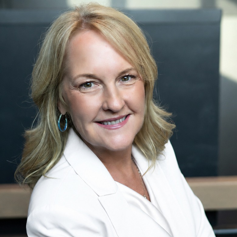 Janet Elliott, founder of Janet Elliott Credit Consulting, smiling in a white blazer.